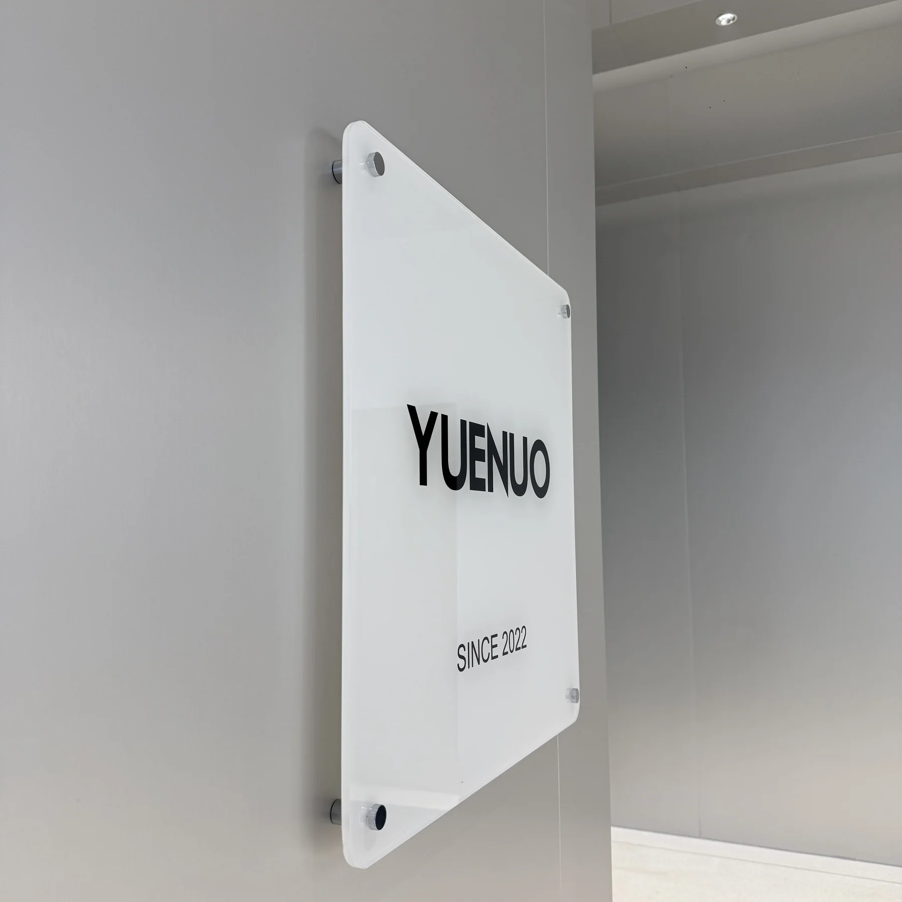 Clear acrylic interior sign mounted with UNIFITTING sign standoffs