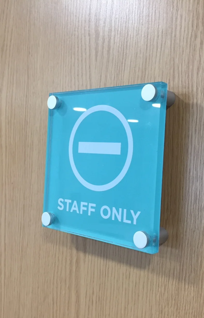 Close-up of aluminium sign standoff hardware for sign fabrication